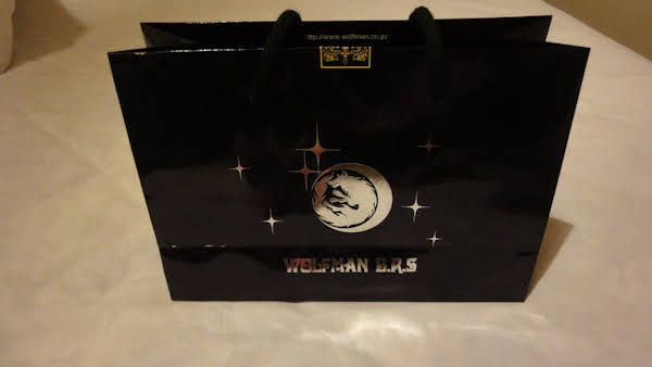 a black gift bag with the wolfman brs logo
